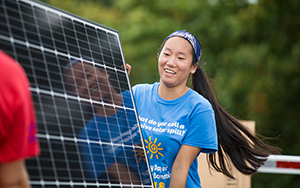 Student moving a solar panel