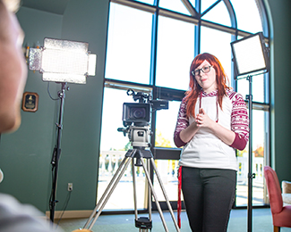 student behind a camera