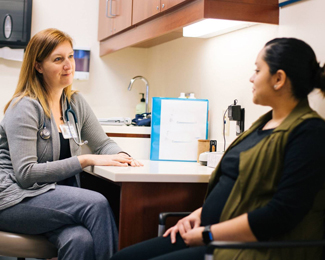 nurse sitting with patient
