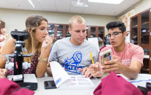 Students looking at calculations in a lab