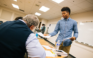 Student handing out presentations in class