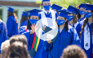 graduates with play button
