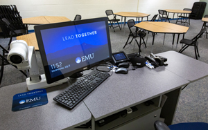 Meeting at a table with a screen