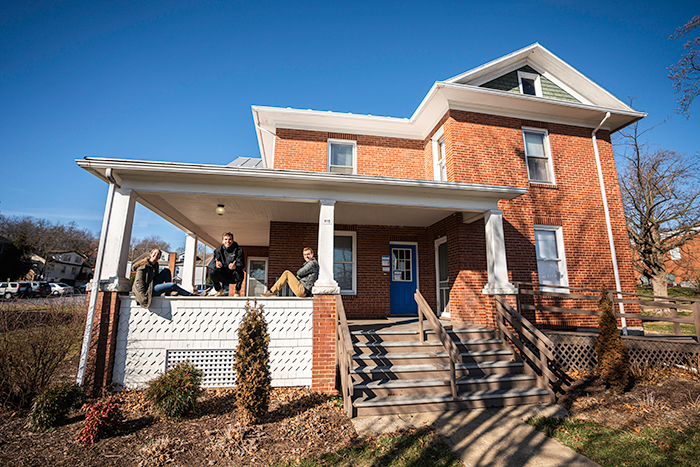 students on the porch of the house they will install a greywater systeem in