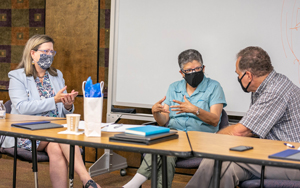 Jackie Font-Guzman speaking with the president and faculty