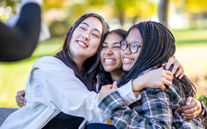 Students hugging and smiling