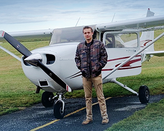 Ian Calhoun with airplane for first solo flight
