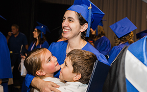 graduate hugging her children