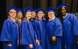 graduates standing together and smiling