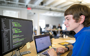 student looking at code on a computer