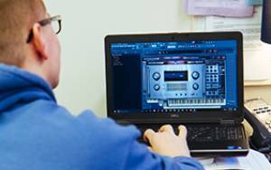 student composing on a computer
