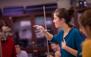 student working with physics experiment