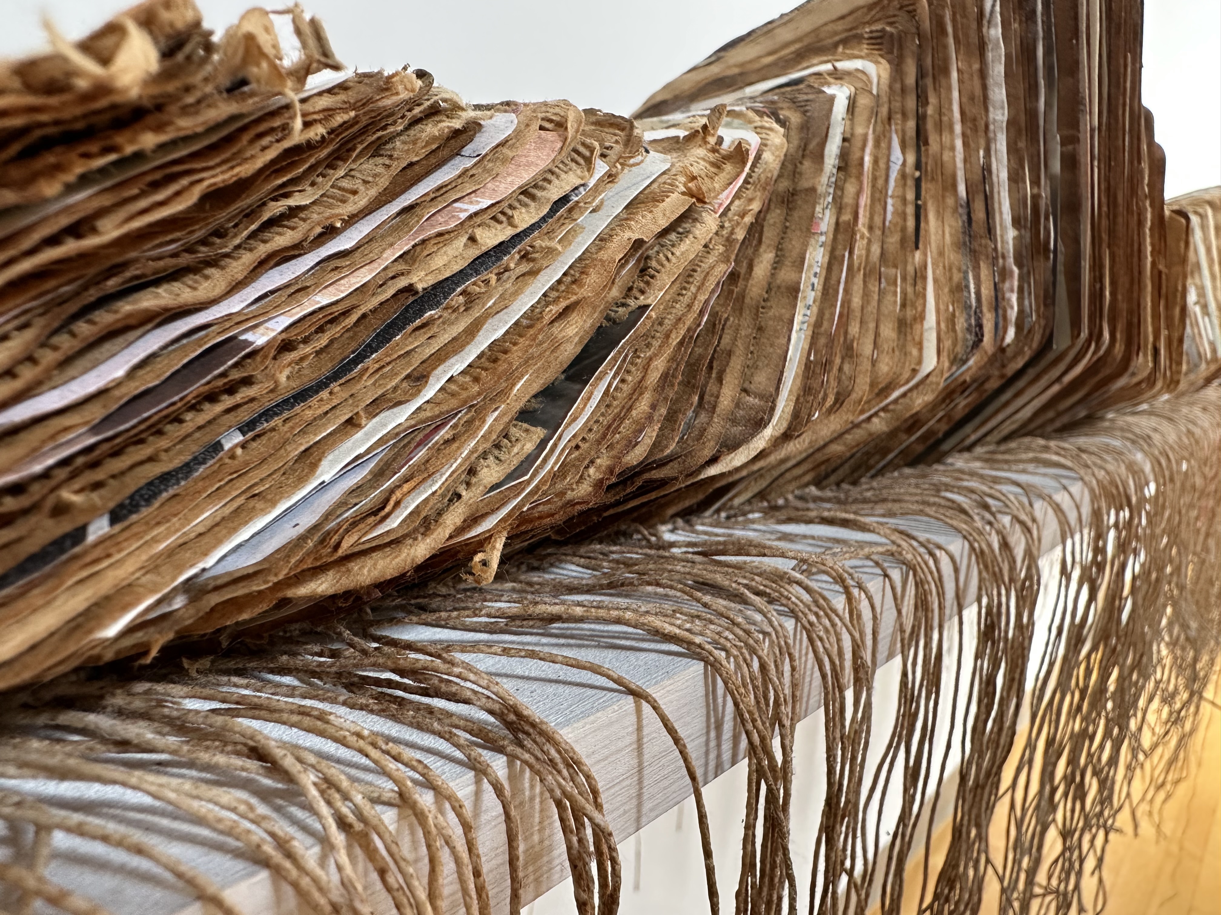 leaning stach of cardboard and paper with strings