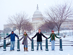 EMU Washington Semester Students holding hands in front of Capitol in the snow
